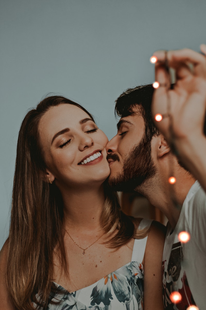 Close-up Photo of Man Kissing a Girl