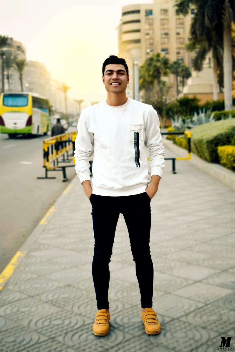 Man in White Crew-neck Sweater Taking Selfie Beside Street Road